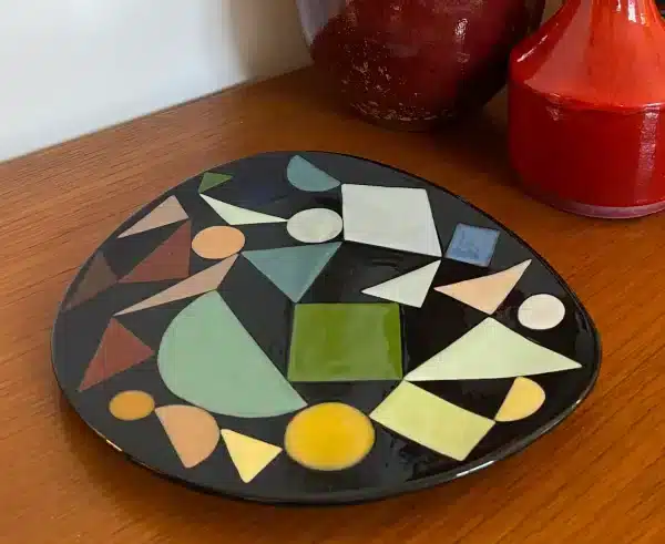 Triangular plate decorated with multicolored geometric shapes