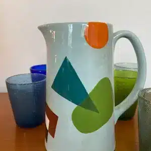 Light blue jug decorated with colored geometric shapes