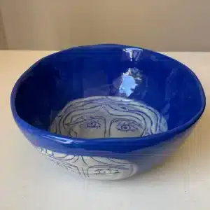 Blue salad bowl handshaped "heads"